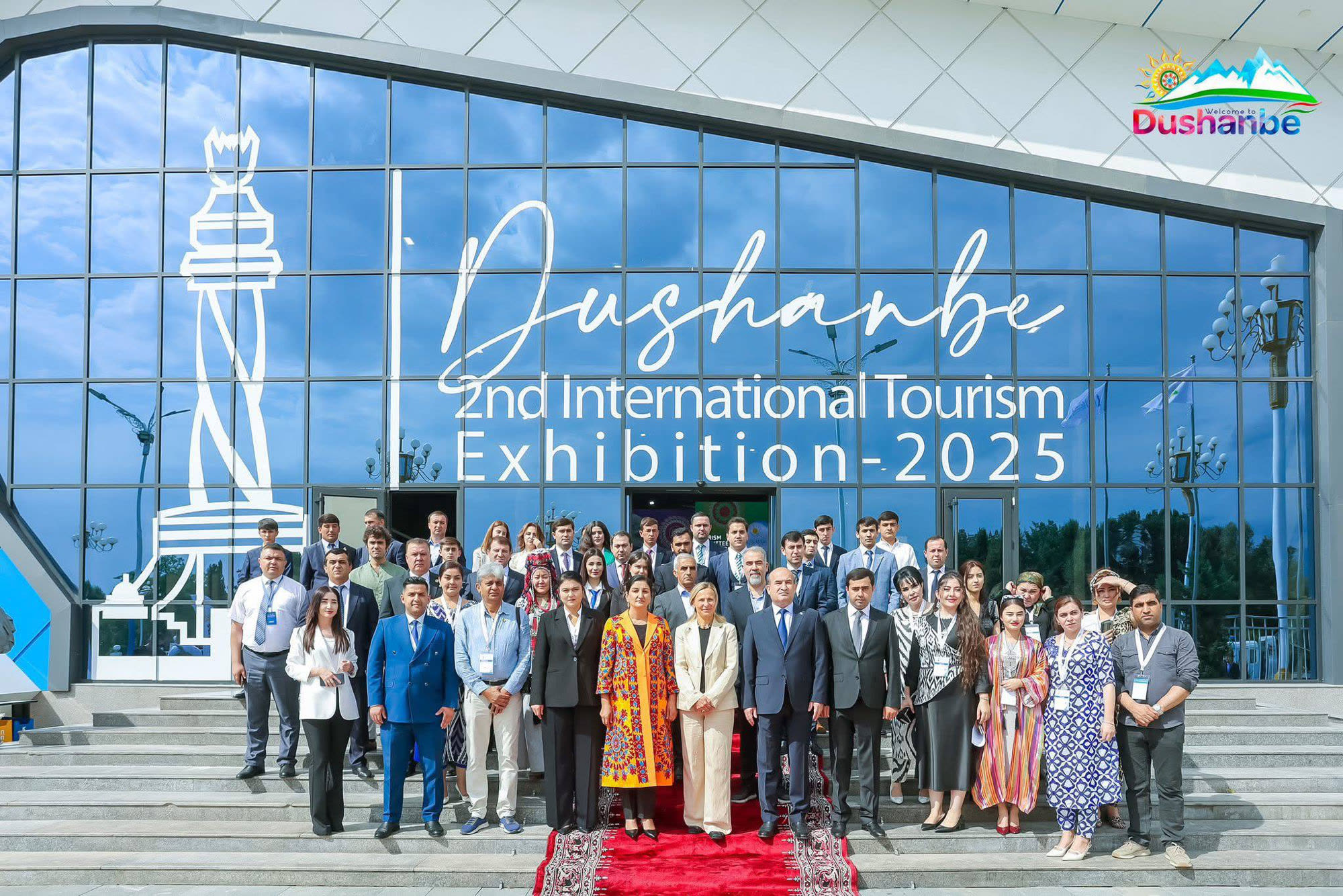 A large delegation gathered on the steps of the Dushanbe Expo Center, the exhibition’s name lettered on the glass facade behind them